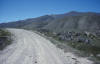 Looking west at the scarp of the Red Rock fault, at Little Sheep Creek. The scarp was trenched in 1986, to the right of the road.