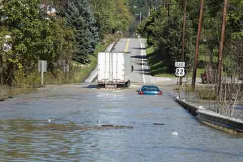 Road under water with vehicles